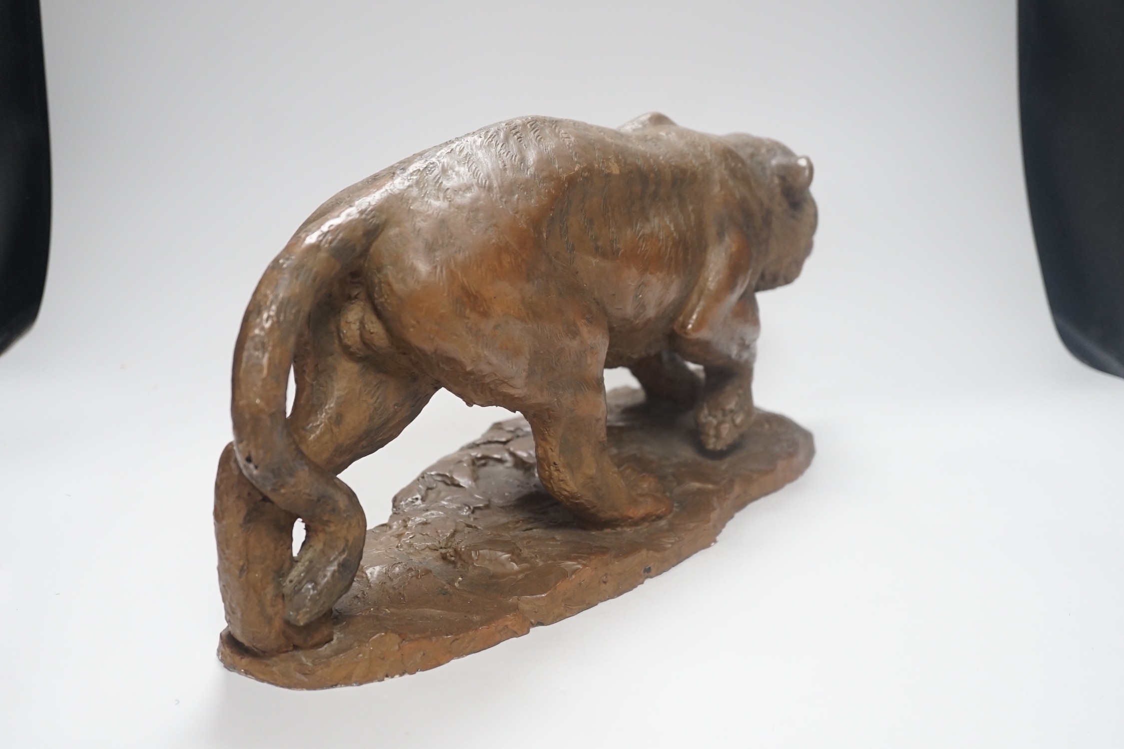 A cold cast resin bronze model of a prowling tiger, 45cm long